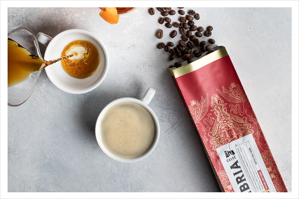 red negroni week coffee bag with beans spilling out, cup of coffee with coffee pouring