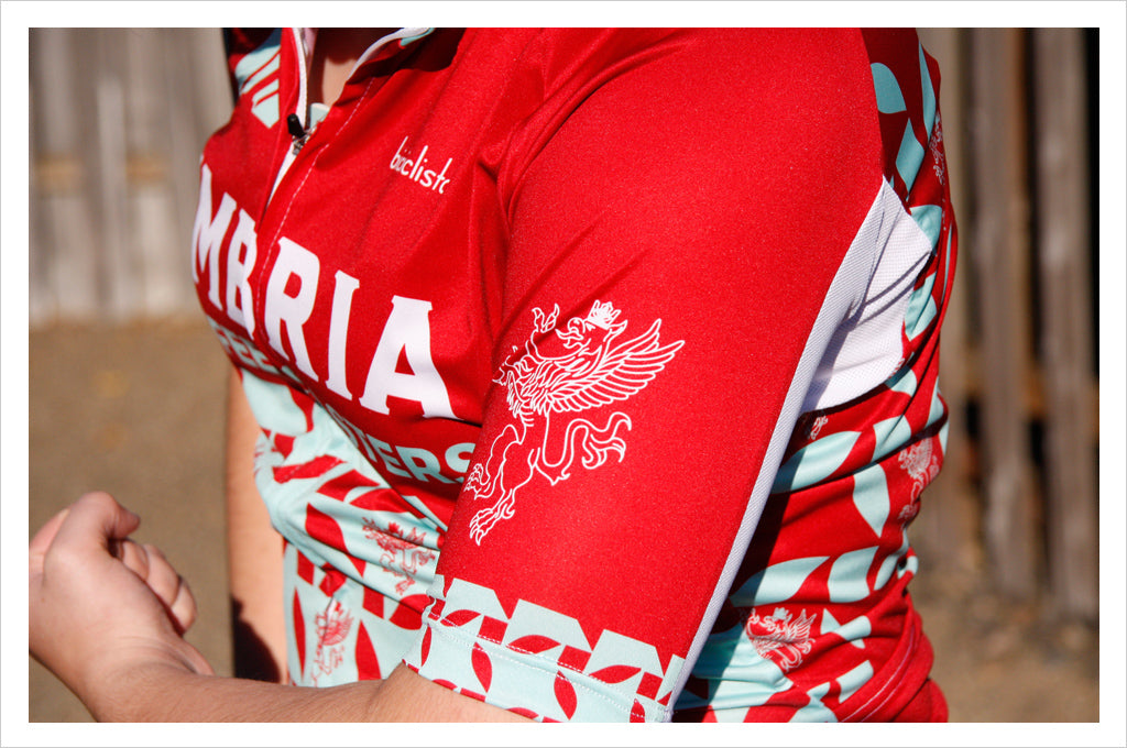 woman wearing red and green umbria cycling jersey