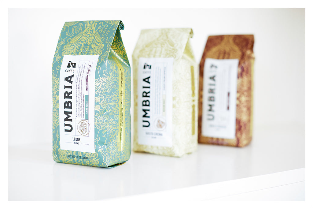 three bags of umbria coffee on a white background