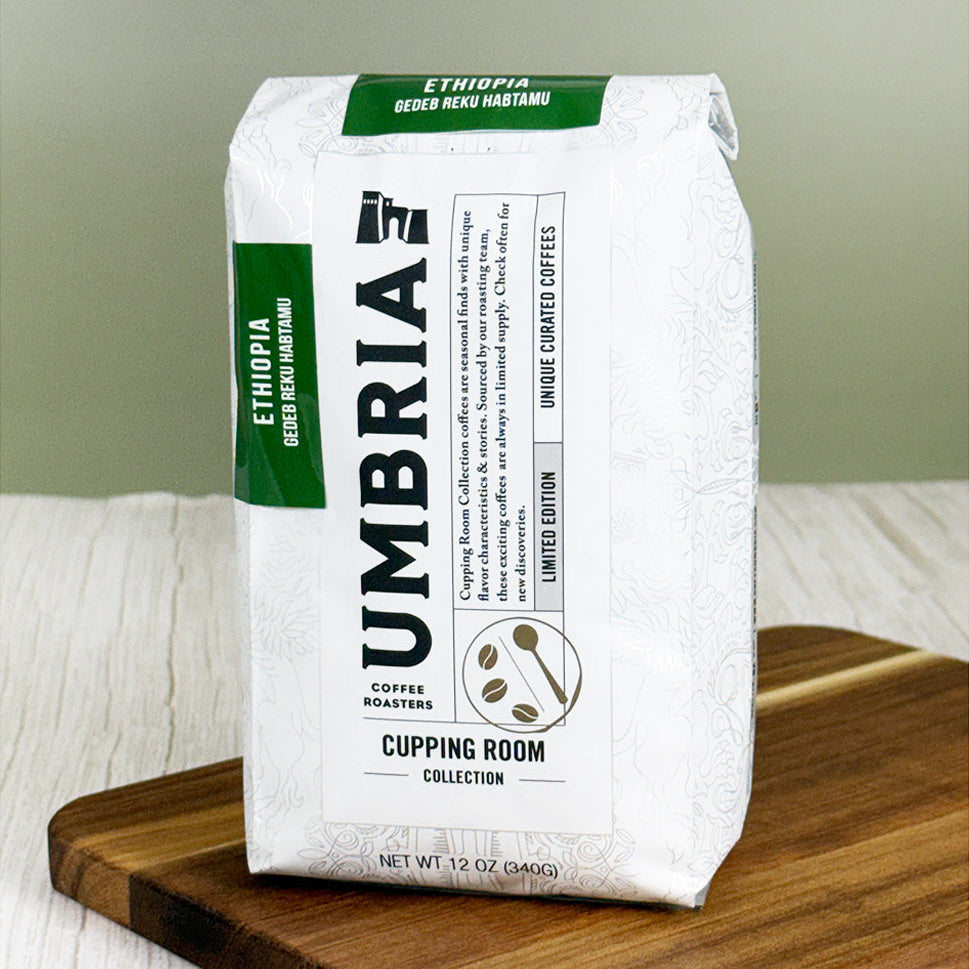 a white bag of Caffe Umbria coffee from the cupping room collection, with a green label for Ethiopia